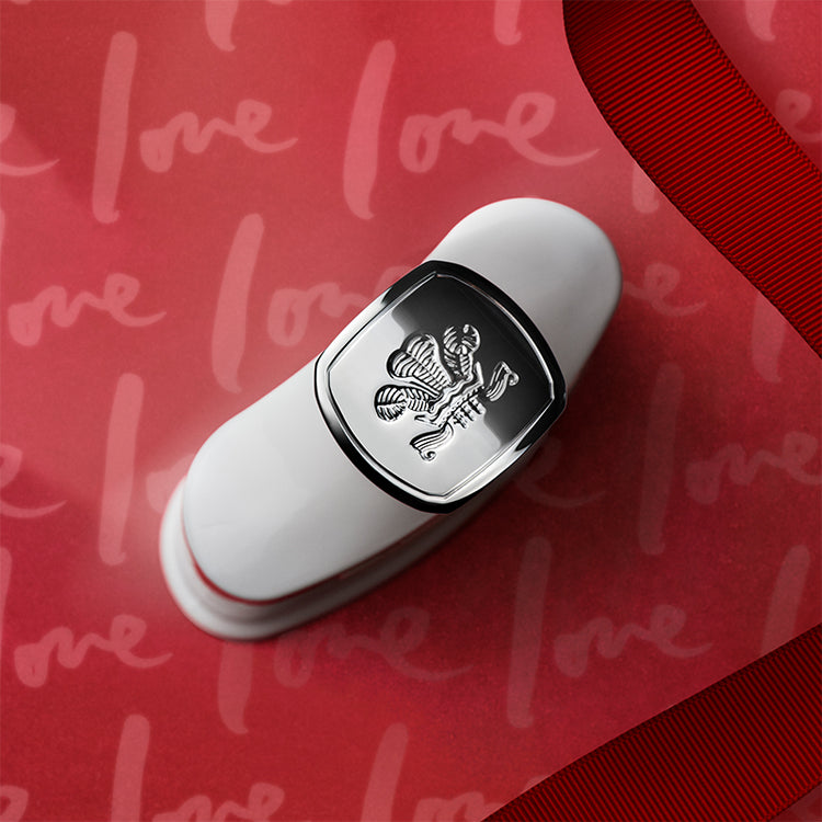 White and silver lip balm with a logo on a red background with 'love' text